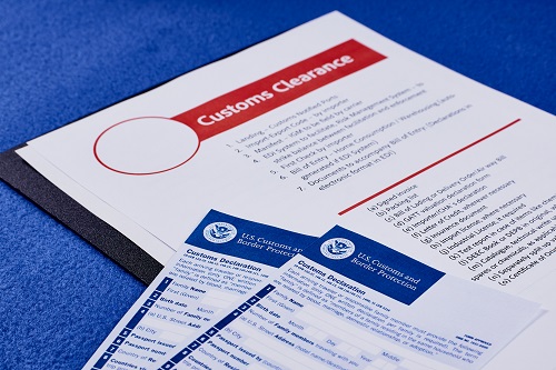 Page with the rules of customs clearance next to forms of the customs declaration